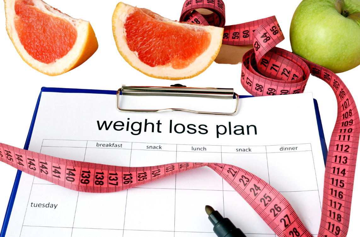 clipboard with weight loss plan paper, measuring tape and citrus fruit slices beside it