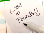 sticky note that says Lose 10 pounds on a calendar
