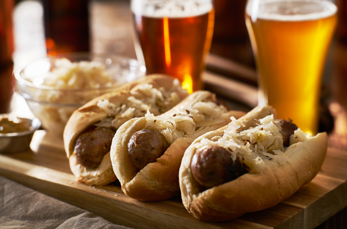 sauerkraut (fermented cabbage) on brats and glasses of beer