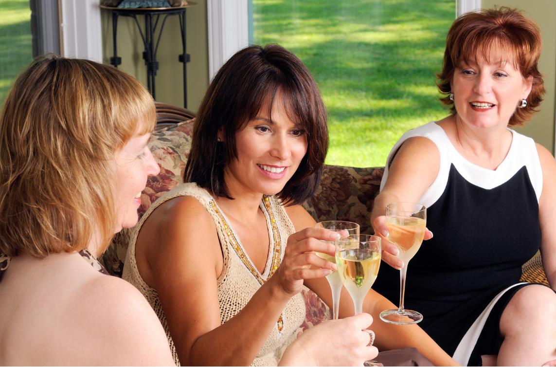 women enjoying a glass of wine together