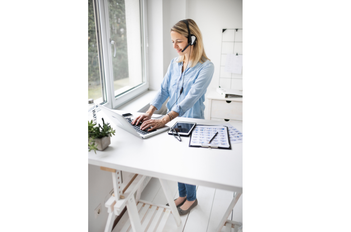 woman working at her sit to stand desk